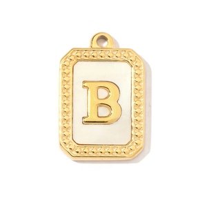 Detailed macro view of a gold-plated stainless steel rectangular pendant with letter B