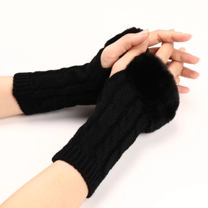 Detailed view of black cable knit fingerless gloves with soft faux fur trim for winter