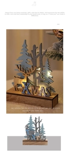 Close-up of Nordic wooden XMAS decor with LED reindeer and fir trees on a timber base