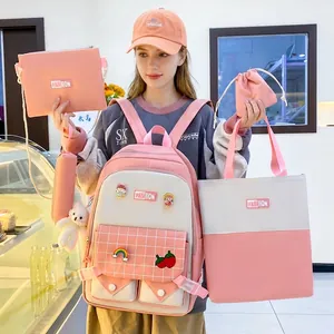 Pink and white 5-piece student backpack set with stylish badges and a cute plush bear charm