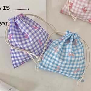 Three-piece drawstring pouch set with plaid patterns and pink bow prints in pastel colors