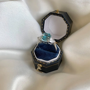 Macro detail of S925 silver ring with blue zircon in a premium velvet gift box
