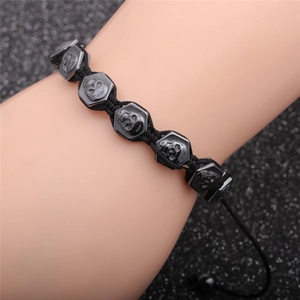 Men's punk braided black cord bracelet with skull hexagon beads on a wrist