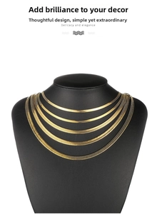 Detail view of five multi-layered gold stainless steel herringbone snake chains on black bust