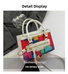 Close-up of rainbow pixel pattern handbag with white trim and gold hardware details