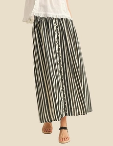 Detail view of black and white vertical striped maxi skirt with button accents and elastic waist