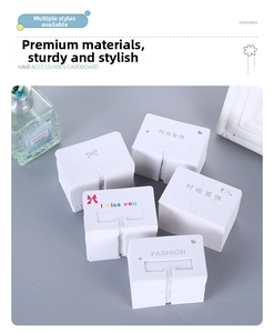 Detailed view of white hair accessory display cards with elegant printed inscriptions