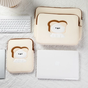 Three sizes of cream laptop sleeves with cartoon dog embroidery and brown zipper trim