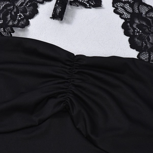 Macro detail of black floral lace neckline and ruched fabric on halter top