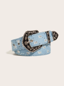 Detail of light blue denim belt with silver studs and ornate vintage metal buckle