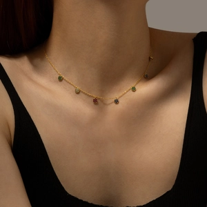 Elegant gold S925 silver necklace featuring colorful round stone pendants on a model