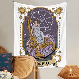 Detail of Scorpio zodiac tapestry with female illustration and sun patterns in a room