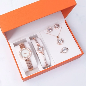 Detailed view of luxury rose gold jewelry set including watch and crystal accessories