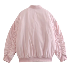 Detail view of the back of a pink bomber jacket with ribbed hem and shirred sleeves