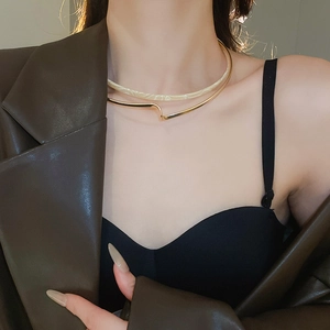Detail of double-layer choker with gold metal and beige marble resin texture