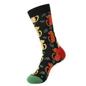 Detail of knit crew socks featuring leopard cartoon prints with green and red accents