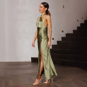 Detailed close-up of olive green satin dress featuring a high side slit and silky texture