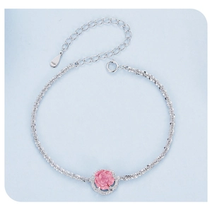 Macro detail of S925 sterling silver bracelet featuring a pink rose and cubic zirconia