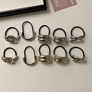 Detailed set of 10 metallic hair ties in gold and silver showing unique geometric textures
