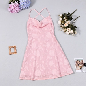 Detailed view of pink floral jacquard dress with cowl neck and thin cross straps