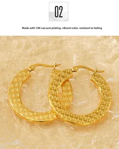 Detail of 18K gold vacuum plated hoop earrings featuring textured star relief patterns