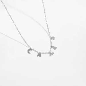 Detail of S925 silver necklace with moon, stars, Saturn, rocket and UFO charms