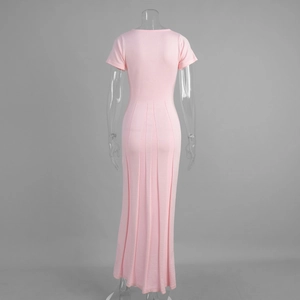 Detail of pink knit maxi dress featuring vertical back pleats and slim fit short sleeves