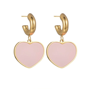 Close-up of gold heart drop earrings with pink finish and elegant tassel design