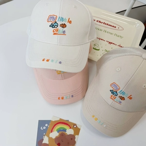 Detailed view of three children's mesh baseball caps with cute sea embroidery