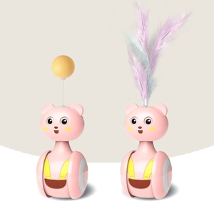 Close-up of pink cat tumbler toy with yellow ball and colorful feather accents