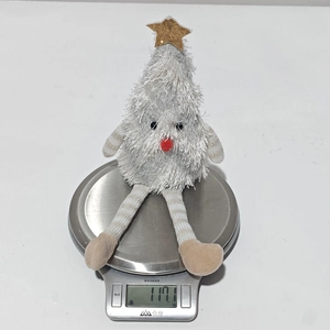 Detailed scale view of the plush white Christmas tree doll weighing 117.1 grams