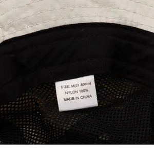 Detail view of quick-dry sun hat showing breathable mesh lining and 100% nylon label