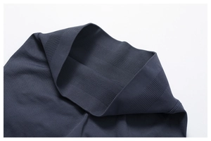 Detail of high-waist ribbed waistband on dark gray seamless yoga leggings with elastic texture