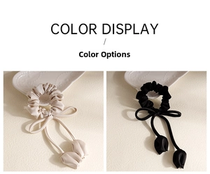 Detailed comparison of cream and black satin tulip ribbon scrunchies on elegant ceramic