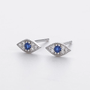 Macro shot of S925 silver Evil Eye stud earrings with blue sapphire and white zircon gems