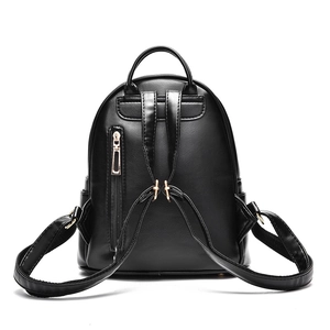 Rear view of a stylish black faux leather backpack for women with golden hardware details