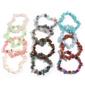 Flat lay detail showing 12 varieties of irregular natural agate and crystal chip bracelets
