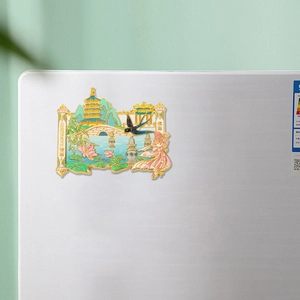 Golden Hangzhou West Lake metal fridge magnet with Leifeng Pagoda on silver laptop