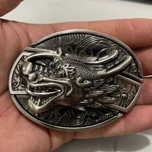 Detailed close-up of antique silver dragon head buckle with 3D embossed texture