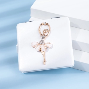 Close-up of white PU leather compact mirror with gold rhinestone ballerina detail