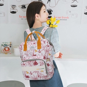 Floral print baby diaper backpack with yellow handles and large storage capacity