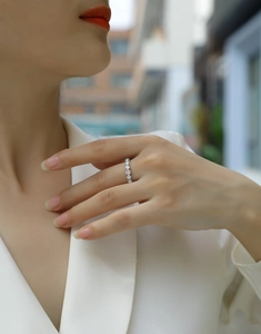 Close-up of a silver S925 ring featuring a sparkling row of round-cut moissanite stones