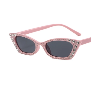 Fashionable pink cat eye sunglasses with rhinestone frame on a clean white background