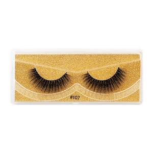 Macro detail of 3D faux mink eyelashes style #107 in gold glitter packaging box
