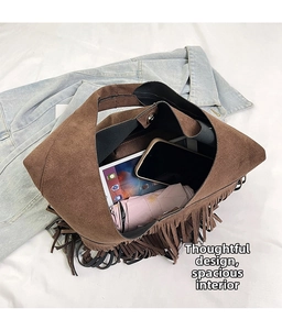 Detail of suede tassel bag interior showing large capacity for tablet and essentials