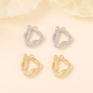 Detailed macro view of snake-shaped jewelry charms with gold and silver plating and zircon