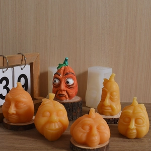 Funny Halloween pumpkin face candle molds with various expressions on wooden stand