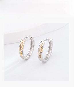 Macro shot showing S925 sterling silver hallmark on two-tone gold and silver hoop earrings