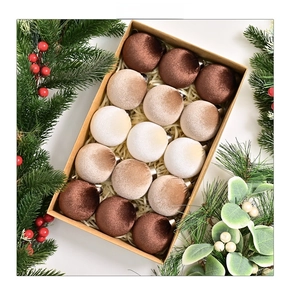 Flat lay of velvet Christmas ball ornaments in coffee tones within a brown craft box