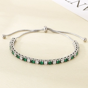 Detail of adjustable slider clasp and green zircon tennis bracelet in stainless steel